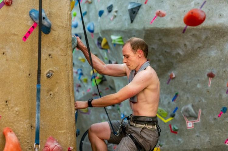 Andrew Dahir climbs on the climbing wall during his record attempt