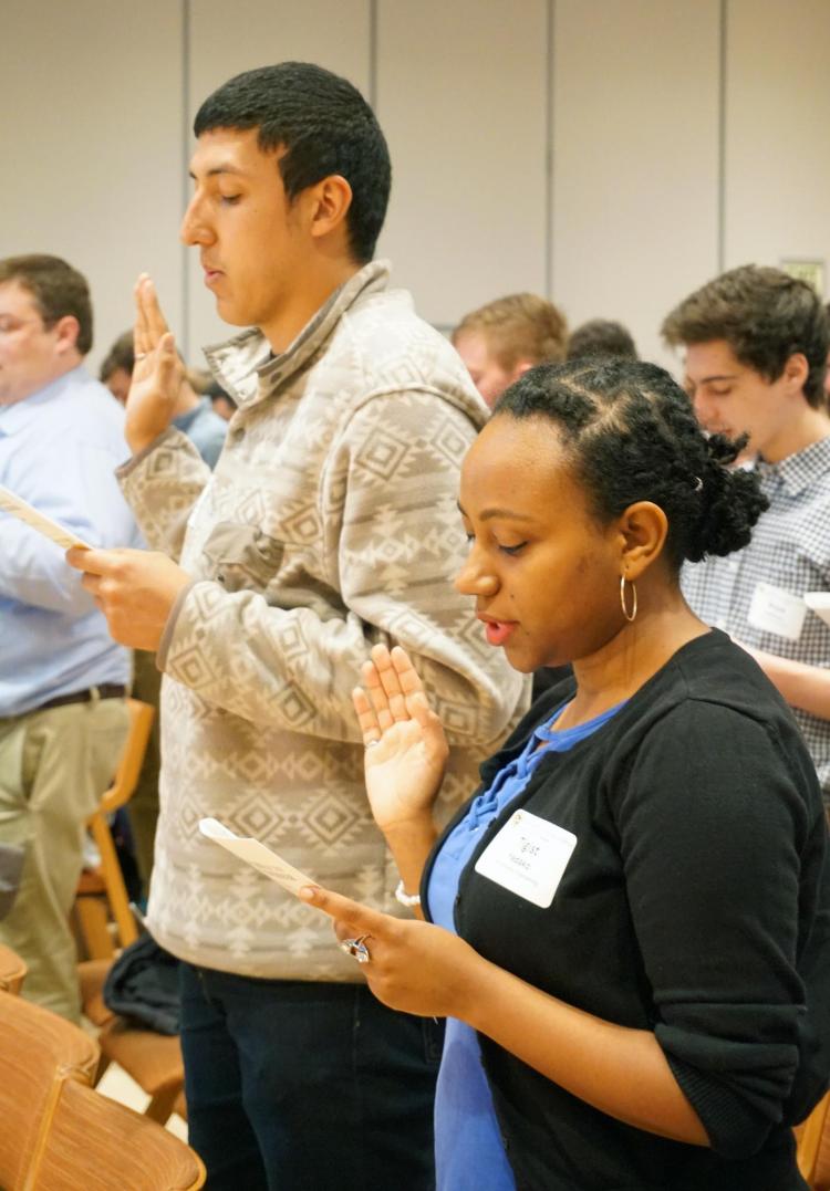 Students take the pledge at the Ring and Pin Ceremony