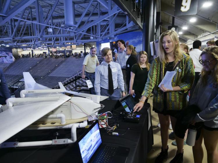 A student shows off her aerospace engineering project at the 2018 expo.