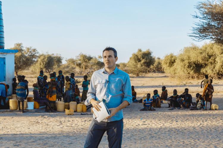 Evan Thomas speaking to a group in the field