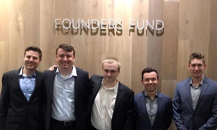 Students participating in Starts H4D stand together at Founders Fund sign