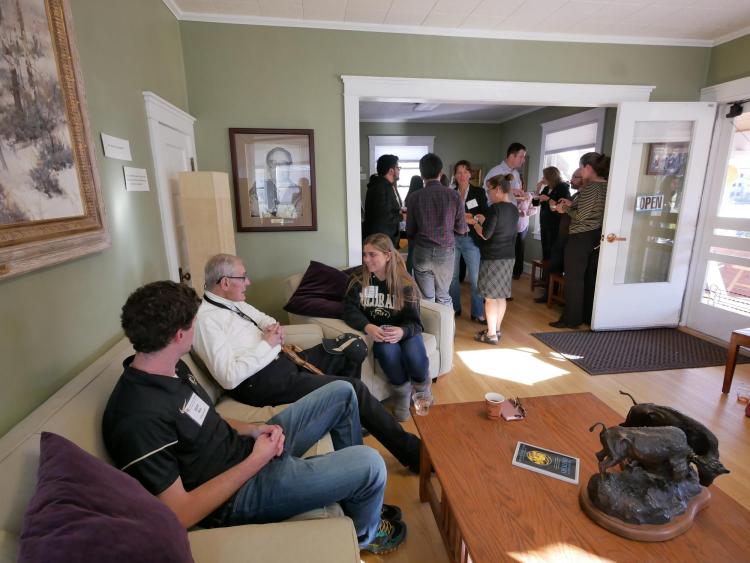 Herbst Program founding donor Clancy Herbst chats with students in the living room of the Lesser House during a party in 2016.