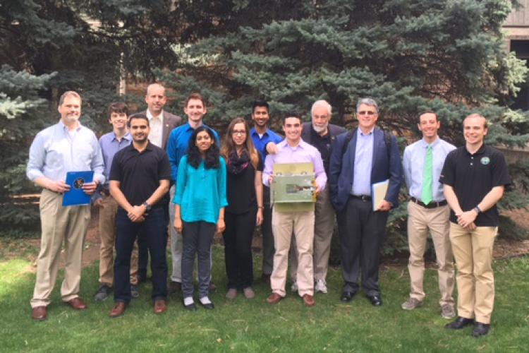 The team stops for a photo with the NASA CubeQuest judges.
