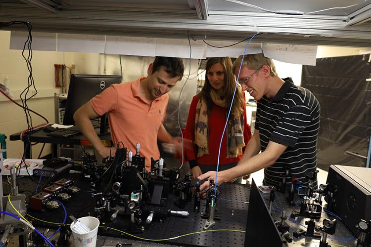 A professor and researcher working together in the lab