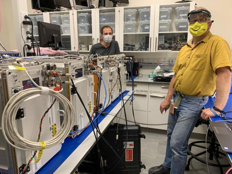 Tobias Niederwieser and Alexander Hoehn in a BioServe laboratory with five FRDIGE units slated for delivery to NASA and the International Space Station.