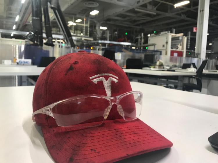 Tesla hat and safety glasses.