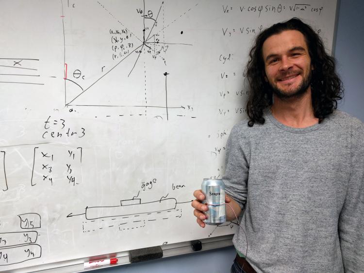 Keith Regner in front of whiteboard with strain gauage.