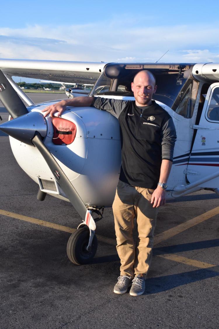 Max Funck, an exchange student from Germany, with small plane.