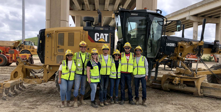Kellisha Ostler and team in front of bulldozer