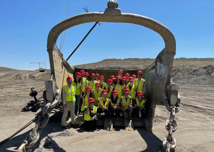 Students in hard hats with heavy equipment