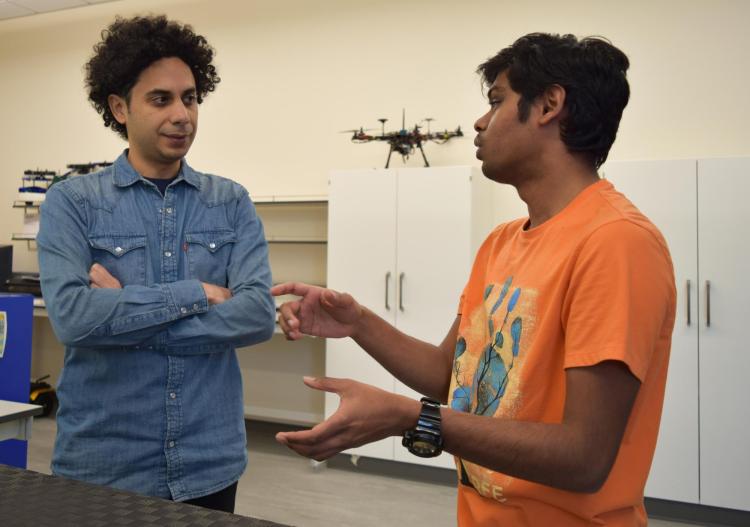 Lahijanian speaking with a student in his lab.