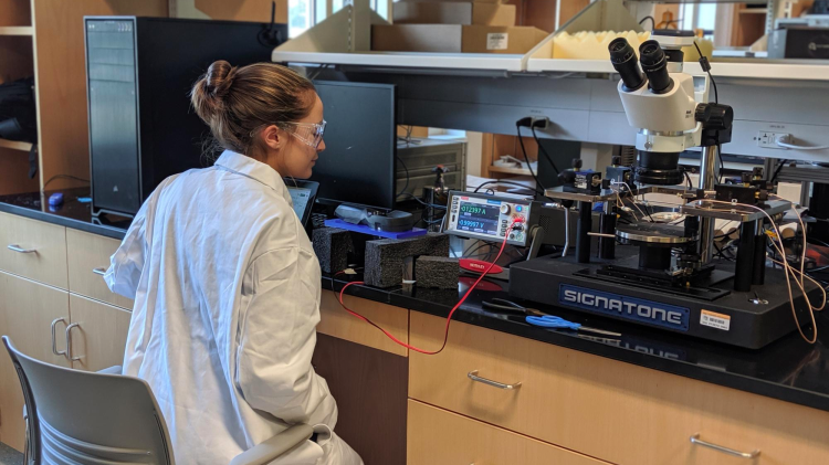 A student working in the lab on electronic sensors