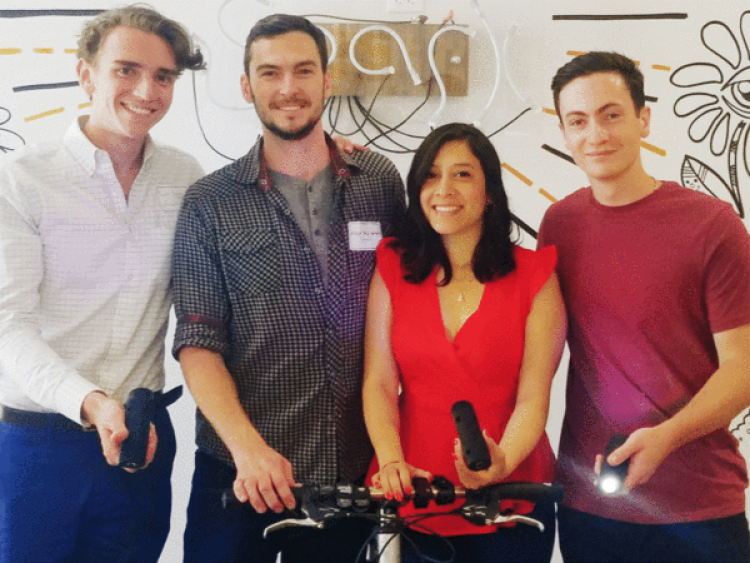 ShineOn team members standing with bike light.