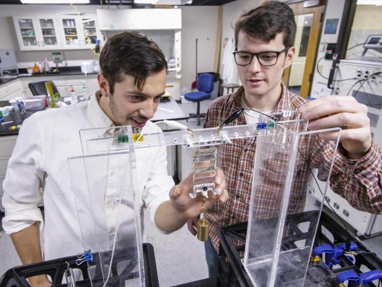 Two students in a lab working with the artificial muscles