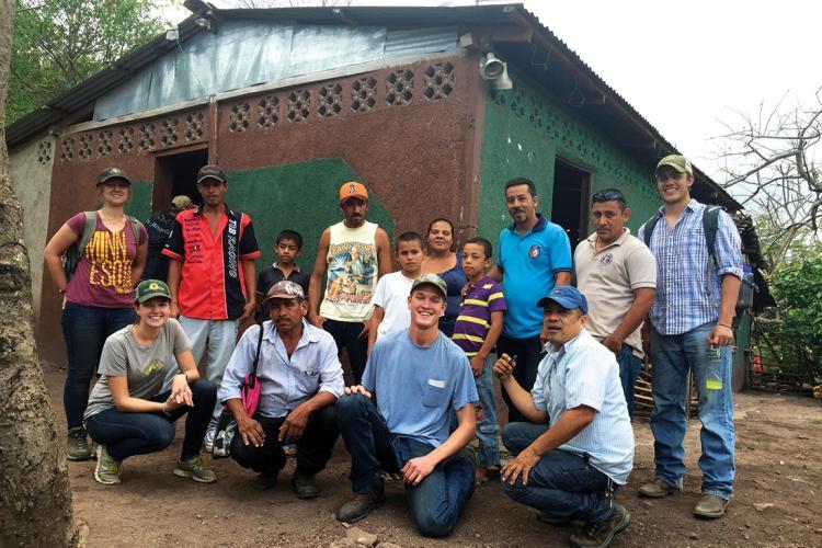 The group poses with villagers who have formed a community solar committee