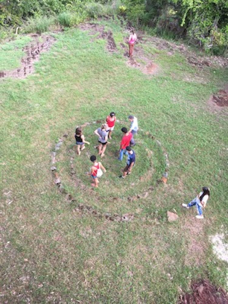 Brazil and US students walk through a natural spiral formation
