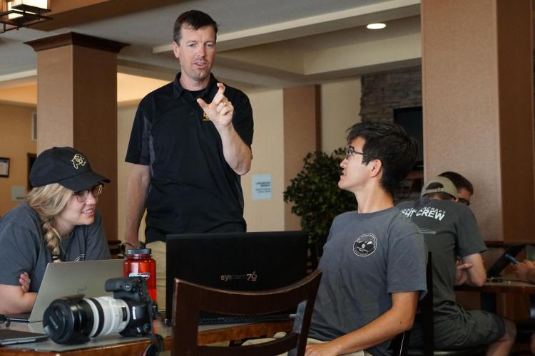 Eric Frew talking with students before a deployment
