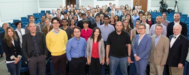 A group shot of the symposium attendees showing Bobby Braun in the front row and Khurram Afridi in the third row.
