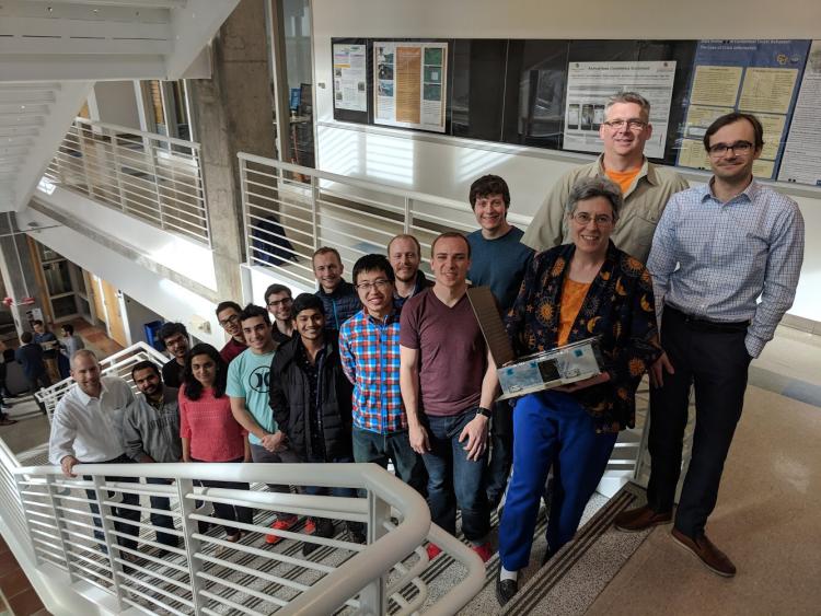 Sarah Withee (at right) holds spring 2018 CUE3 satellite