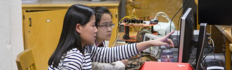 Female students work at computer in embedded systems lab