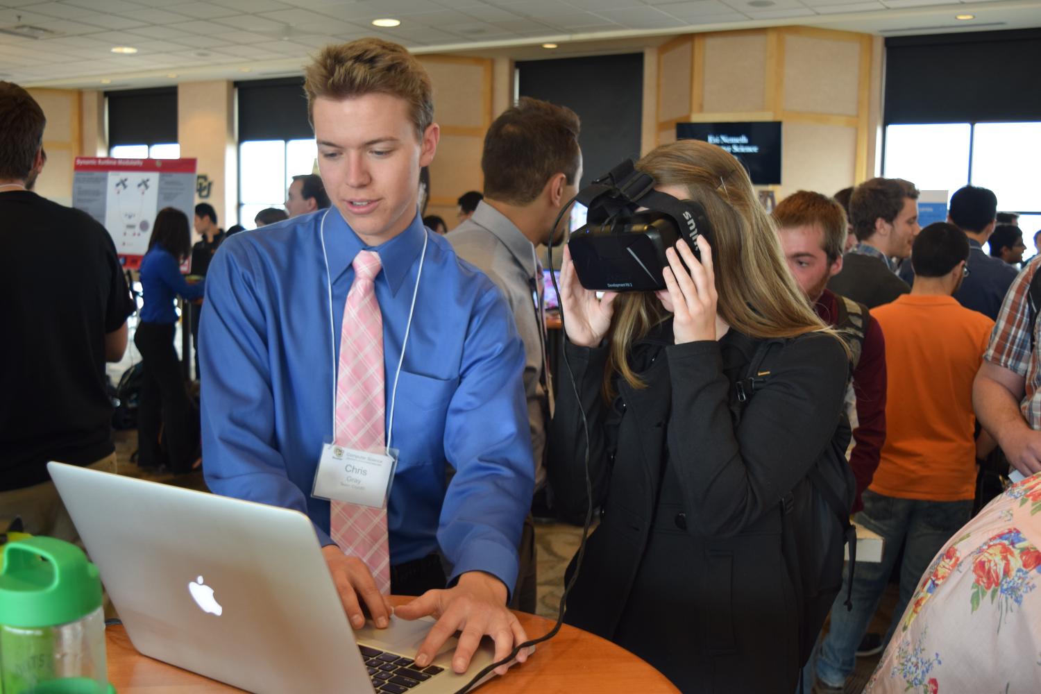 A guest tries out a virtual reality headset at the 2016 computer science expo. 