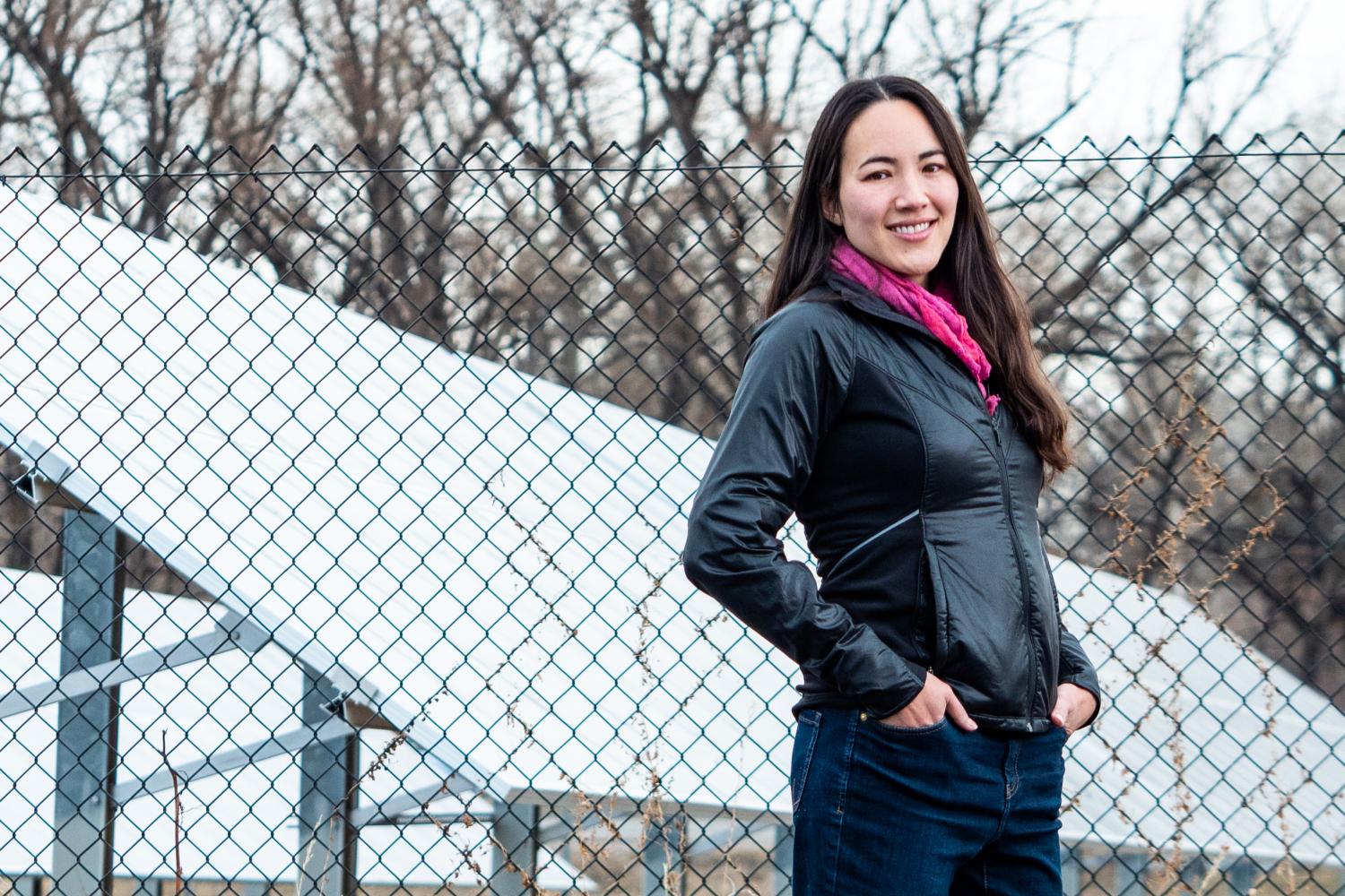 Kyri Baker in front of solar panels