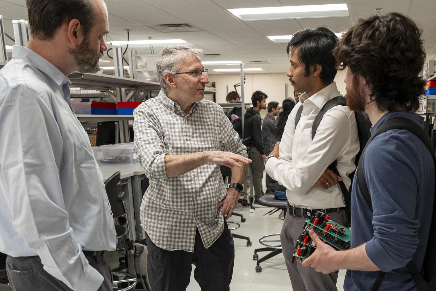 Dragan Maksimovic in the power electronics lab talking with students