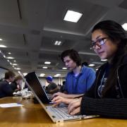 Student work on laptops during the hackathon. 