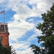 Picture of Old Main on CU Boulder's campus with American Flag 