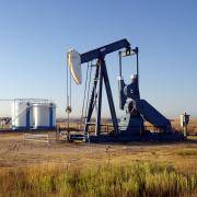 Oil well and storage tanks in a field 