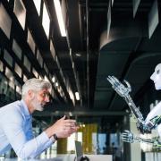A man and a robot talking to each other 