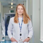 Anna Blakney in lab coat at Imperial College London