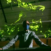 John Crimaldi watches as green laser light illuminates plumes in his lab's test flume. 