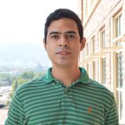 Filipe Henrique in a green striped shirt posing outside of JSCBB