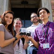 A team of 4 students posing with their Search and Rescue Assistants