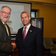 Dean Robert Davis shakes the hand of Lockheed Martin Chief Technology Officer Keoki Jackson after a $3 million partnership forging new academic programs was announced