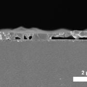 Cross-sectional SEM image of the spin-coated MAPbI3 film processed from DMF precursor solution (annealed for 5 s at 100 °C) on a PTAA-covered ITO glass substrate.