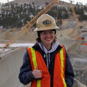 Reese Jillian Hopp in a hardhat in front of a construction site