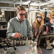 Scott Diddams in his lab with students