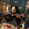 A graduate student and professor in the aerospace fabrication lab at CU Boulder