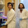 Two men in white lab coats conducting research.