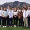 group of students posing for picture with flatirons in the background