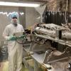 Telikicherla holding the instrument next to a sounding rocket body.