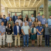 Fall 2025 cohort of new CU Engineering faculty standing on stairs between concrete pillars.