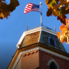A USA flag flying over CU Boulder campus