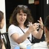 Abbie Liel makes a point with her hands to a Maui resident who lost their home while a Notre Dame student researcher looks on.