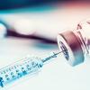 Syringe drawing a vaccine