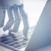 Robot hand touching computer 