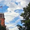 Picture of Old Main on CU Boulder's campus with American Flag 