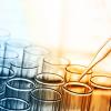 Test beakers being filled in blue and orange light
